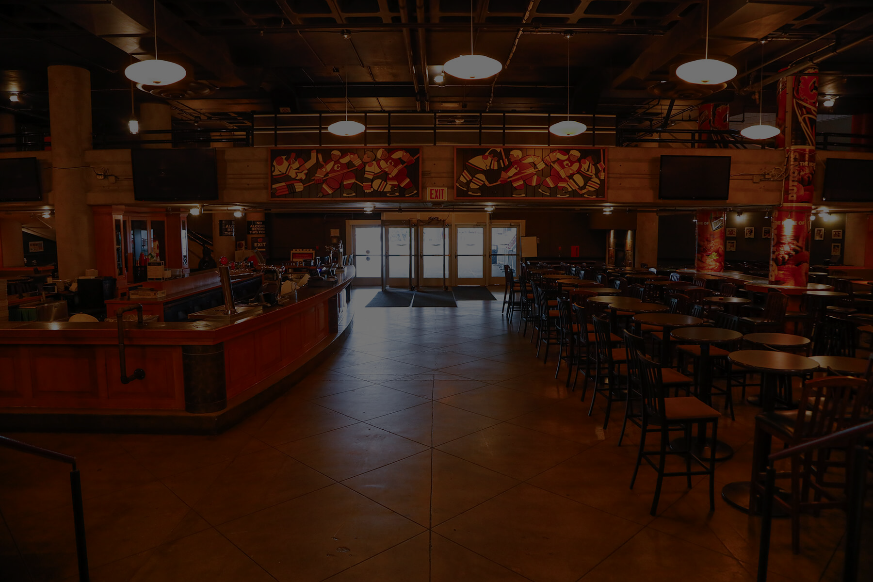 Dutton's lounge empty with the large bar on the left and bar tables and chairs to the right