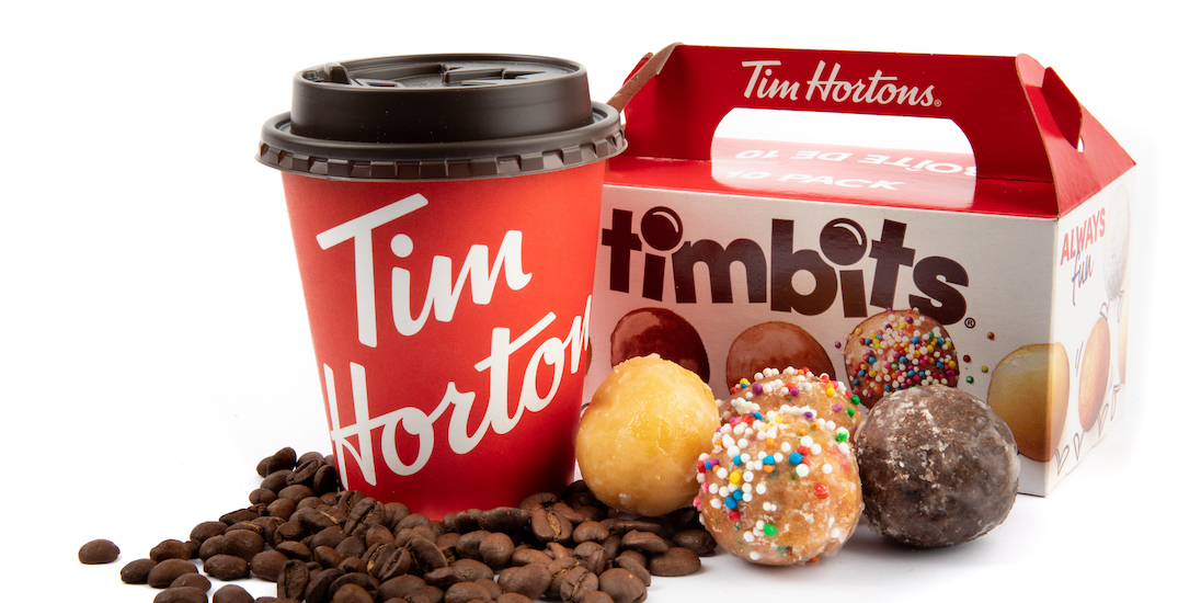 A Canadian bilingual box of Tim Horton's Timbits showing the English text of Tim Horton's coffee surrounded by coffee beans suggesting freshness